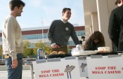 Duncan Carvey (far left), Luke Pulaski and Rudy Ramirez (far right) man a table outside Tuesday's City Council meeting, campaigning against plans to build a 4,000-slot Indian casino at Point Molate. Photo by Ian A. Stewart.