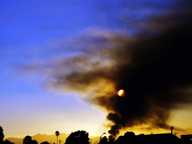 Smoke obscures the sky as the fire at the Chevron refinery burns on Monday evening.