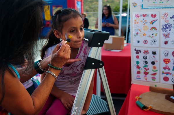Six-year-old Ailish Badillo gets her face painted at one of the vendor booths at the El Grito celebration. (Photo by: Erik Reyna)