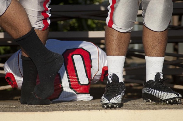 Prior to the game, Kennedy players got dressed on the bleachers. (Photo by Tyler Orsburn)