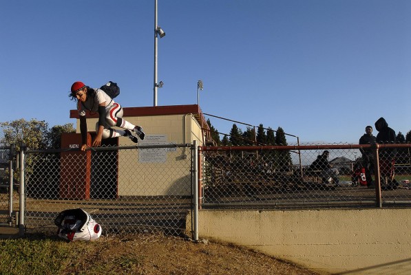 Roman Espinoza jumps over a fence to head to the locker room prior to the game against Joseph Bethel. Bethel went on to defeat Kennedy Friday night in Vallejo, 27-16. (Photo by Tyler Orsburn)