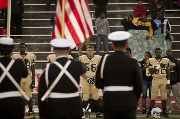 Joseph Bethel players salute the flag during the national anthem. Bethel went on to defeat Kennedy Friday night in Vallejo, 27-16. (Photo by Tyler Orsburn)