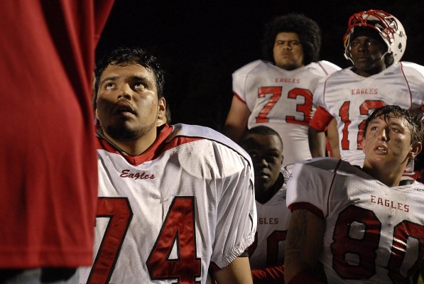Jesus Patino, 74, and the rest of his teammates listen to head coach Mark Carminer during halftime. Bethel went on to defeat Kennedy Friday night in Vallejo, 27-16. (Photo by Tyler Orsburn)