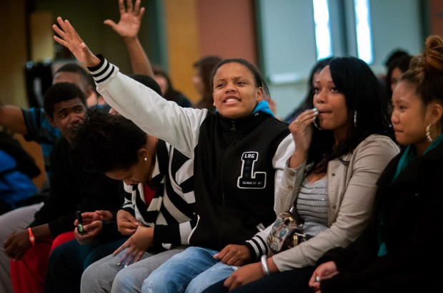 Two Kennedy High School students cheer at candidate during political forum.