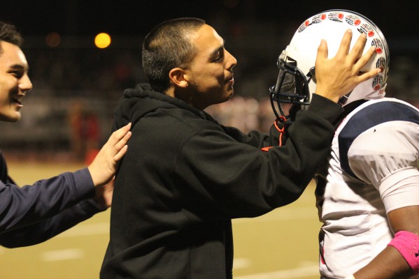 Former player Anthony Luna congratulates a teammate as victory becomes apparent. (Photo: Avni Nijhawan)