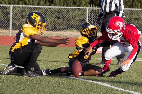 The Pee Wee Steelers team tries to bring down Oak Grove. (Photo by: Lauren Kate Rosenblum)