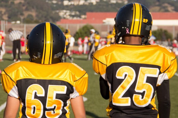 Two young Steelers players watch from the sidelines. (Photo by: Lauren Kate Rosenblum)