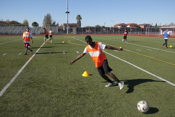First-time player Bryant Payne learns ball control during Monday's practice. Still using Chuck Taylor All-Star sneakers to play soccer, Payne said he never thought about playing soccer until he had a PE class. (Photo by: Tyler Orsburn)