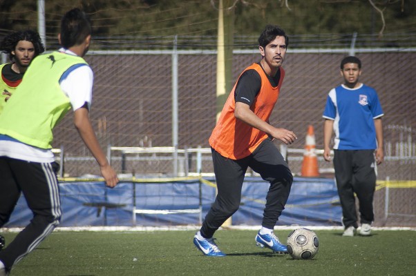 Kennedy head coach Aaron Colacion practices with the team. "If every kid that was a good soccer player that played outside of school was here, and eligible, we'd have one of the best teams in the county," he said. (Photo by: Tyler Orsburn)