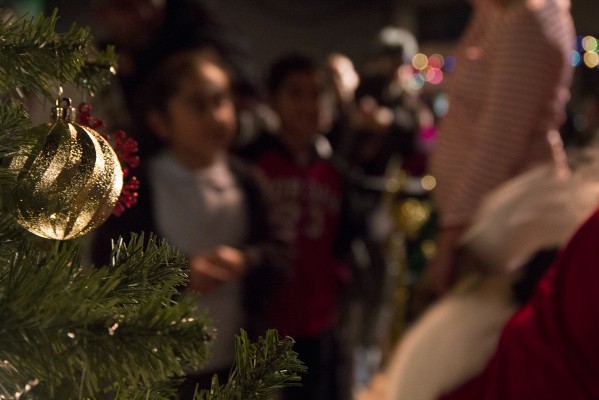 Children line up at the East Bay Performing Arts Center to take a picture with Santa. (Photo by: Stephen Hobbs)