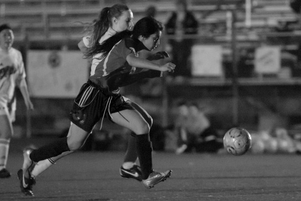 Senior Jacqueline Sanchez fights off a defender, while trying to gain possession of the ball. Sanchez is the only senior on the Oilers' squad. (Photo by: Lauren Kate Rosenblum)
