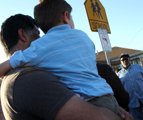 As the crowd grew more emotional, family members and friends huddled in close to support each other. Photo by: Anne Hoffman.