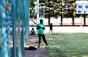Roderick Jones, 13, warms up for batting.