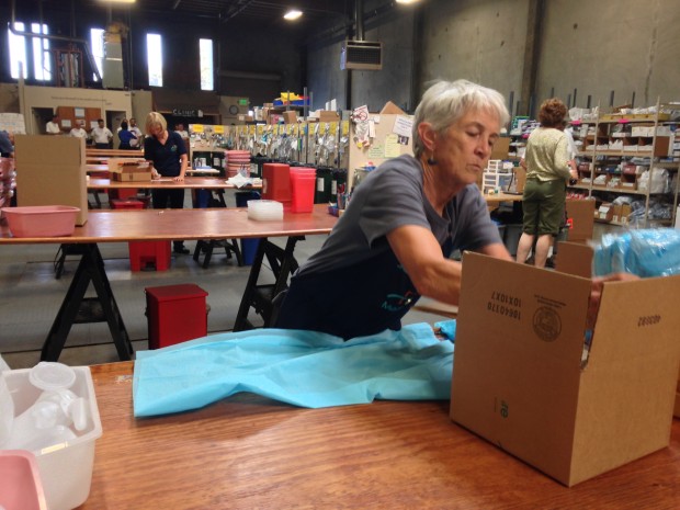 A volunteer for the last five years, Marsha Felton boxes up supplies in MedShare's San Leandro warehouse. (Photo by Pallavi Somusetty)